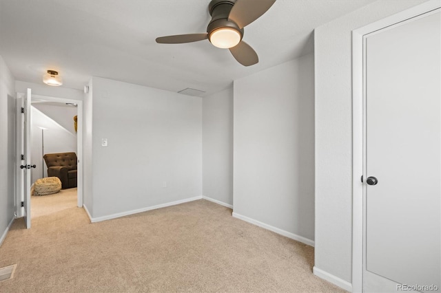 carpeted empty room featuring ceiling fan