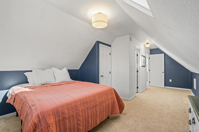 bedroom featuring light colored carpet, lofted ceiling, and a textured ceiling