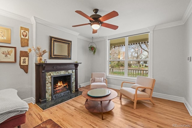 2336 N High St, Denver, CO 80205 - living area with a warm lit fireplace, ceiling fan, ornamental molding, and wood finished floors
