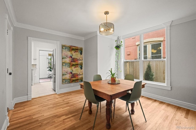 2336 N High St, Denver, CO 80205 - dining space featuring crown molding and light wood finished floors