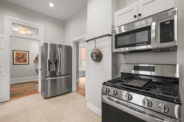 2336 N High St, Denver, CO 80205 - kitchen with stainless steel appliances, white cabinetry, and recessed lighting