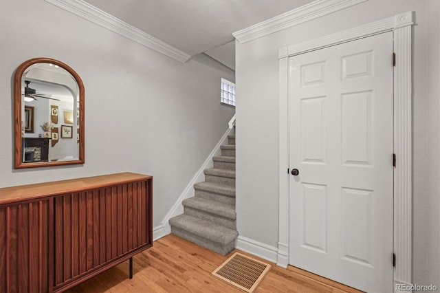 2336 N High St, Denver, CO 80205 - staircase featuring ornamental molding, wood finished floors, and ceiling fan