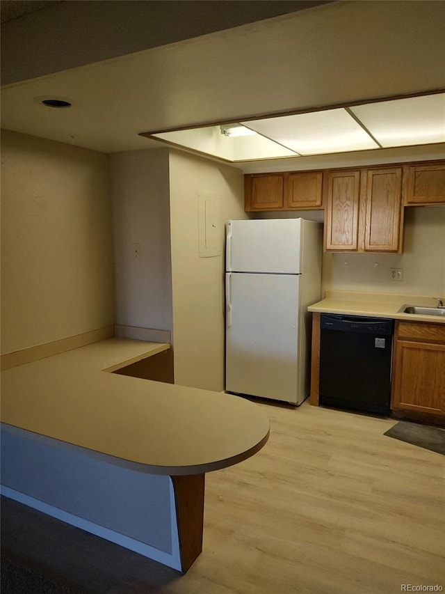 kitchen with dishwasher, light wood-type flooring, sink, white fridge, and kitchen peninsula