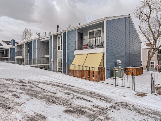 snow covered house with a balcony