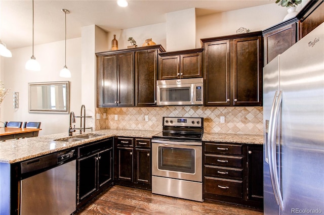 2346 Central Park Blvd, Denver, CO 80238 - kitchen with appliances with stainless steel finishes, a sink, tasteful backsplash, dark wood-style flooring, and light stone counters