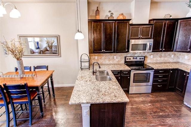 2346 Central Park Blvd, Denver, CO 80238 - kitchen featuring stainless steel appliances, a sink, dark wood-style flooring, dark brown cabinets, and a chandelier