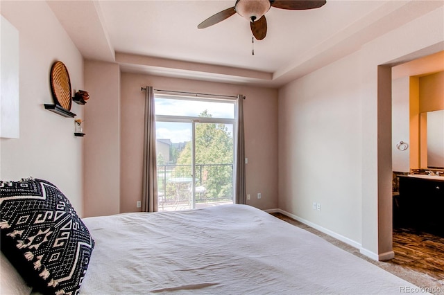 2346 Central Park Blvd, Denver, CO 80238 - bedroom featuring access to outside, baseboards, a tray ceiling, carpet floors, and connected bathroom
