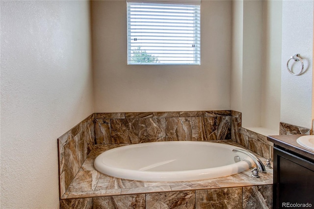 2346 Central Park Blvd, Denver, CO 80238 - bathroom featuring vanity, a bath, and a textured wall