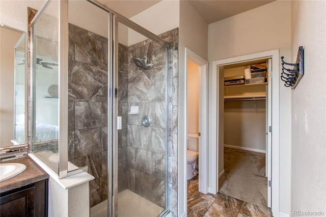 2346 Central Park Blvd, Denver, CO 80238 - bathroom with toilet, a spacious closet, a shower stall, vanity, and marble finish flooring