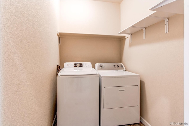 2346 Central Park Blvd, Denver, CO 80238 - washroom featuring washing machine and clothes dryer and a textured wall