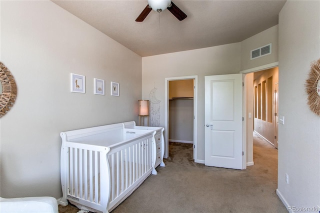 2346 Central Park Blvd, Denver, CO 80238 - carpeted bedroom featuring baseboards, a walk in closet, a ceiling fan, and a closet