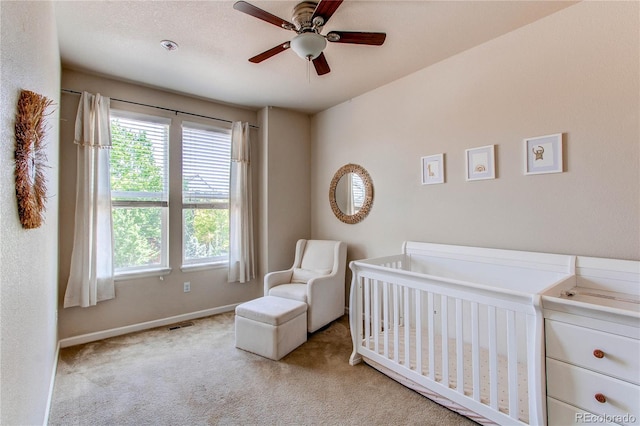 2346 Central Park Blvd, Denver, CO 80238 - carpeted bedroom featuring multiple windows, a nursery area, baseboards, and ceiling fan
