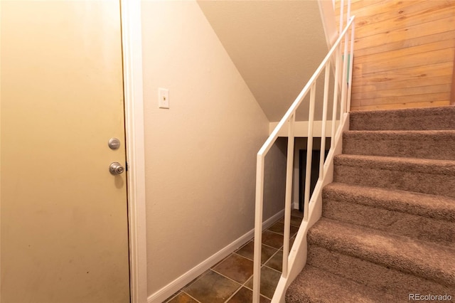 stairs with tile patterned floors and baseboards