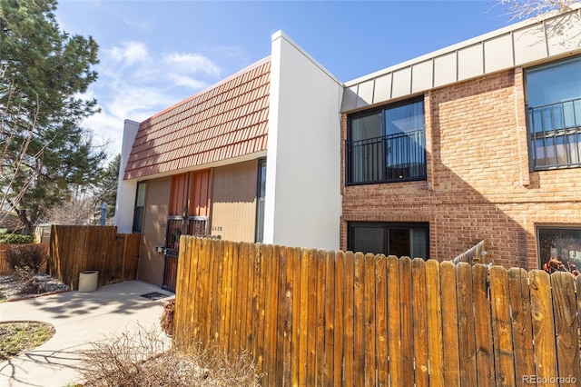 view of building exterior with fence