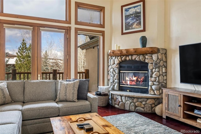 living room featuring plenty of natural light, dark hardwood / wood-style flooring, and a fireplace