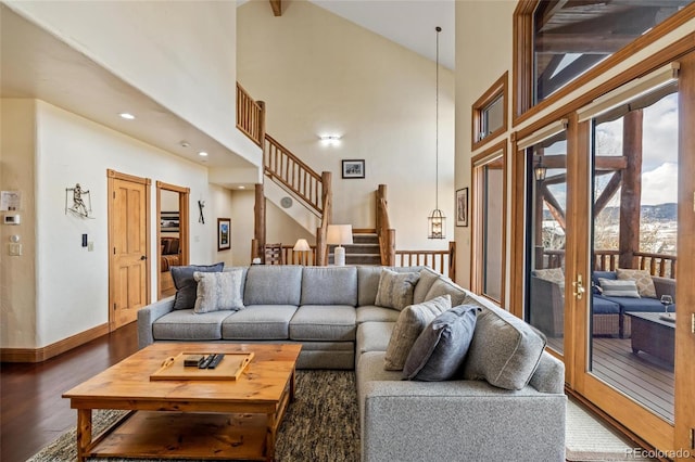 living room with wood-type flooring and high vaulted ceiling