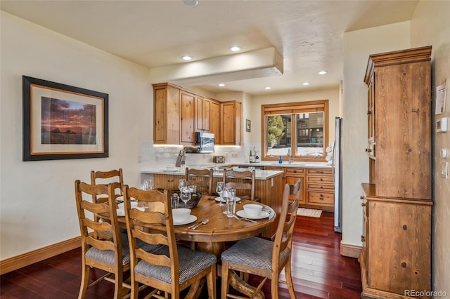 dining space with dark hardwood / wood-style flooring