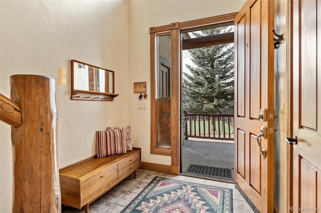 doorway with light tile patterned floors