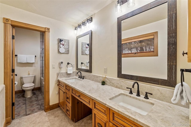 bathroom featuring tile patterned floors, vanity, and toilet