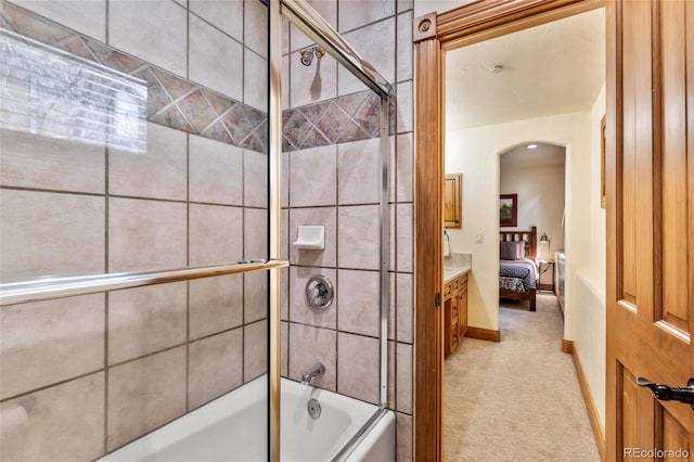 bathroom with vanity and enclosed tub / shower combo