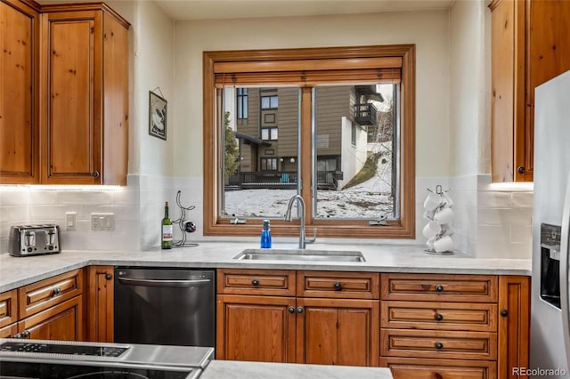 kitchen with tasteful backsplash, sink, and appliances with stainless steel finishes