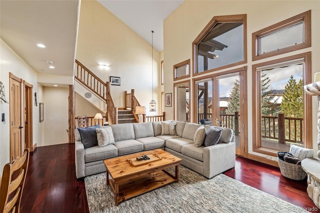 living room with dark hardwood / wood-style flooring and high vaulted ceiling