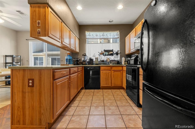 kitchen with kitchen peninsula, ceiling fan, light tile patterned floors, and black appliances