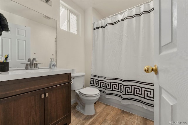 bathroom featuring toilet, vanity, and hardwood / wood-style flooring