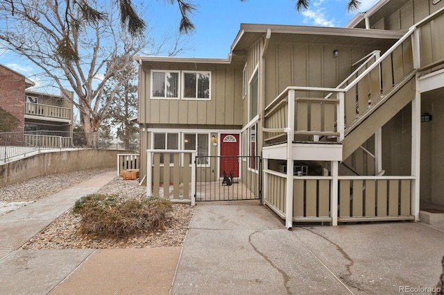 view of front of house featuring a gate, board and batten siding, and fence