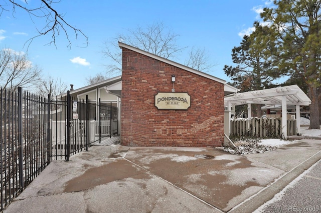 exterior space featuring a pergola and fence