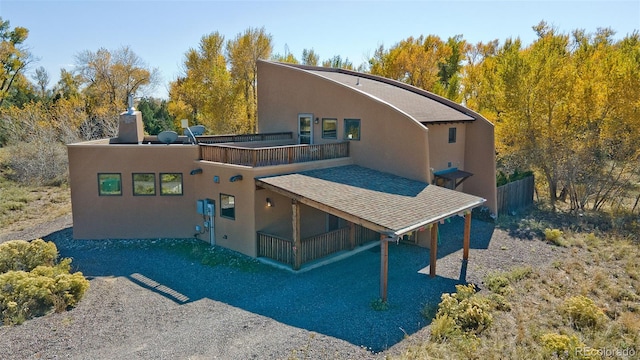 back of property with a balcony