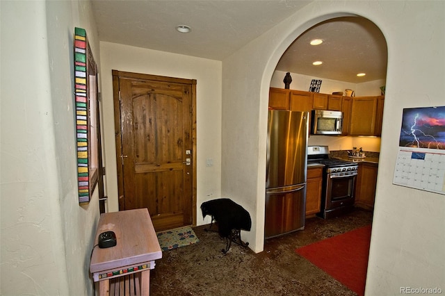 interior space with dark colored carpet and appliances with stainless steel finishes