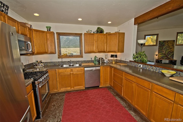 kitchen featuring kitchen peninsula, appliances with stainless steel finishes, and sink