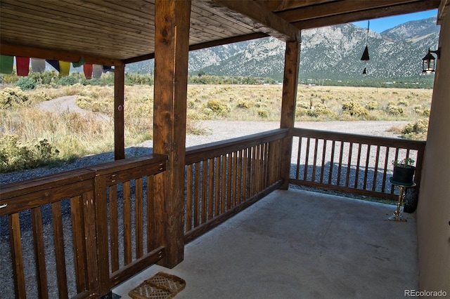 wooden terrace with a rural view and a mountain view