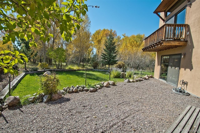 view of yard with a balcony