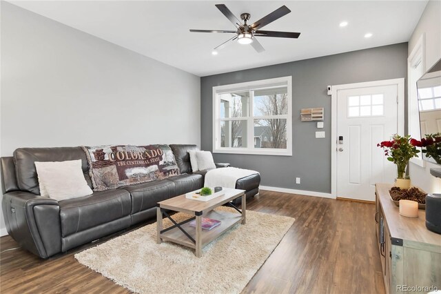 living room featuring a ceiling fan, recessed lighting, dark wood-style flooring, and baseboards