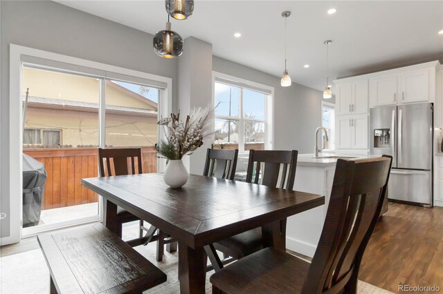 dining space featuring dark wood-type flooring and recessed lighting