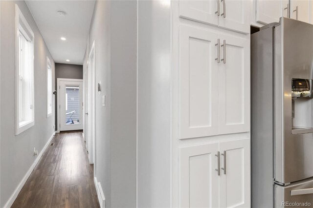 hallway featuring dark wood-type flooring, recessed lighting, and baseboards