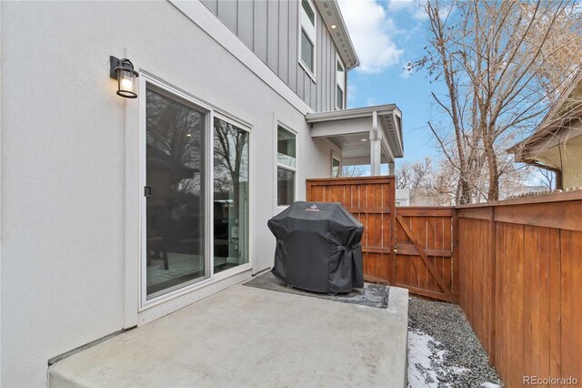 view of patio / terrace with a gate, fence, and area for grilling