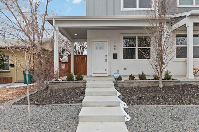 entrance to property with board and batten siding and stucco siding