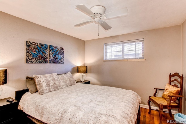 bedroom with ceiling fan, baseboards, and wood finished floors