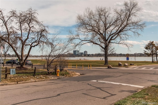 view of road with curbs and a water view