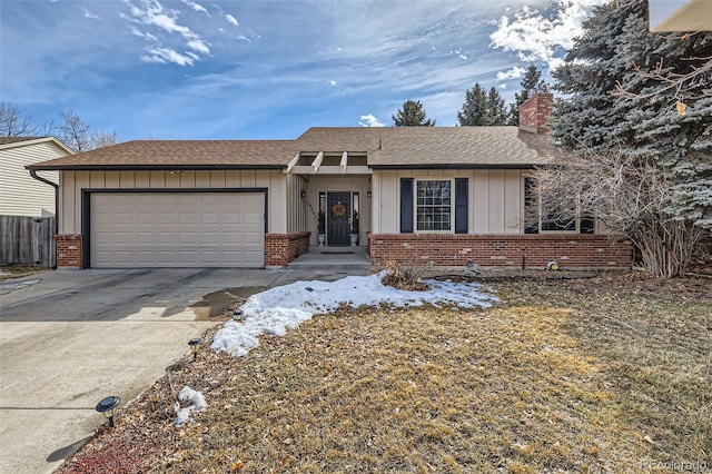 ranch-style home with concrete driveway, brick siding, board and batten siding, and an attached garage