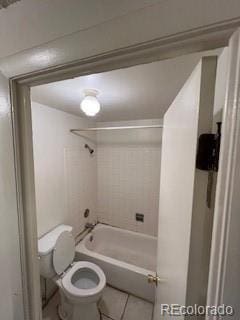 bathroom with bathtub / shower combination, toilet, and tile patterned floors