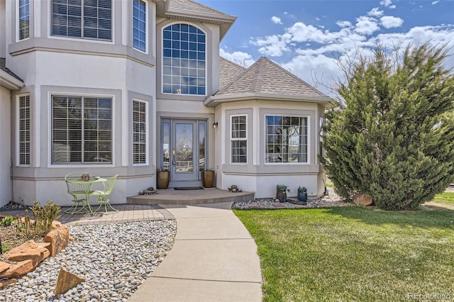29852 E 163rd Pl, Brighton, CO 80603 - doorway to property featuring a shingled roof, a lawn, and stucco siding