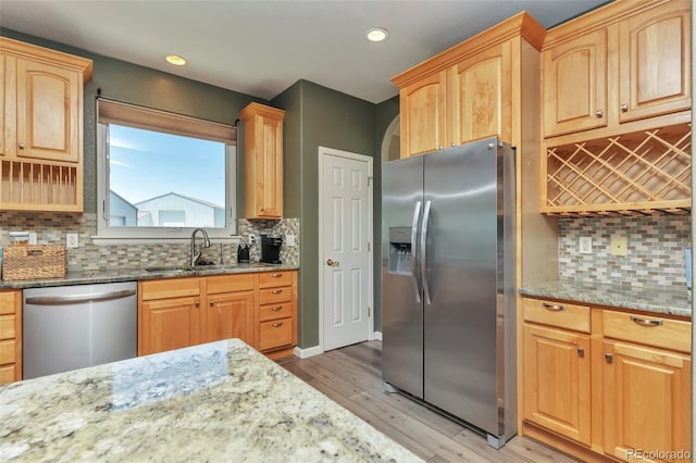 29852 E 163rd Pl, Brighton, CO 80603 - kitchen with stainless steel appliances, light wood-style flooring, light stone counters, recessed lighting, and backsplash