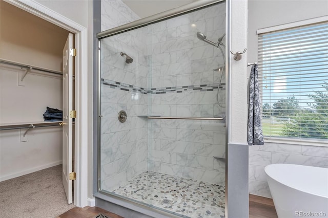 29852 E 163rd Pl, Brighton, CO 80603 - bathroom featuring a stall shower, a soaking tub, and a spacious closet