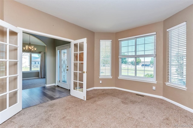 29852 E 163rd Pl, Brighton, CO 80603 - carpeted spare room with french doors, a chandelier, and plenty of natural light