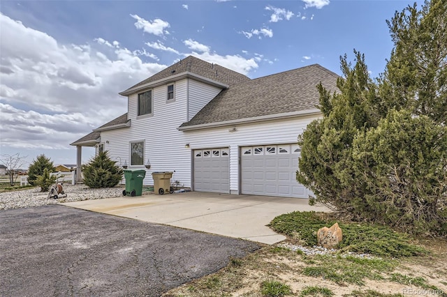 29852 E 163rd Pl, Brighton, CO 80603 - view of side of home with driveway, roof with shingles, and a garage