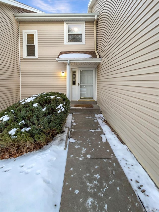 view of snow covered property entrance